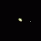 Saturn as it appears through a steadily-held pair of binoculars